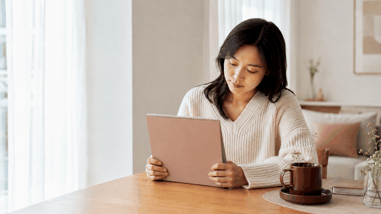 부천 생리지연 – 수첩으로 생리 주기를 확인하는 여성